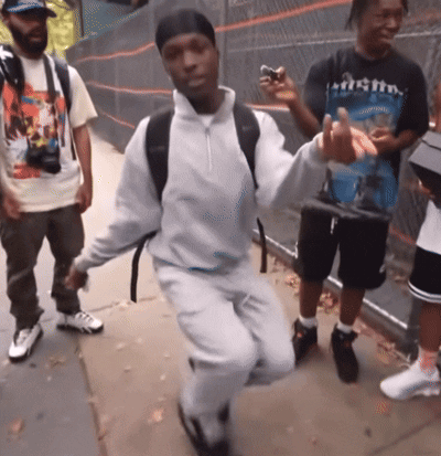 A Man In A T-Shirt That Says Mighty Is Dancing GIF