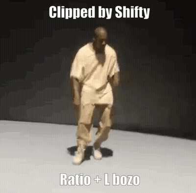 A Man In A Tan Shirt And Khaki Pants Is Dancing On A White Floor . GIF