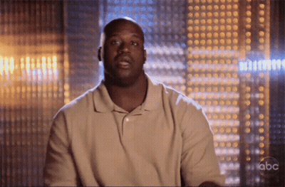 A Man In A Tan Shirt Is Sitting In Front Of A Abc Sign GIF