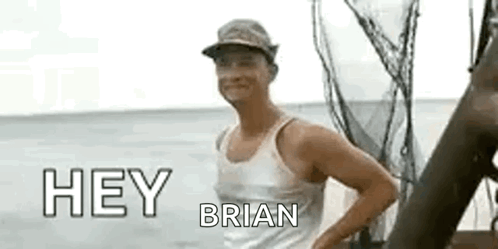 A Man In A Tank Top And Hat Is Standing On A Boat In The Water . GIF