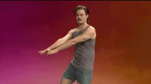 A Man In A Tank Top And Shorts Is Standing In Front Of A Pink And Orange Background . GIF