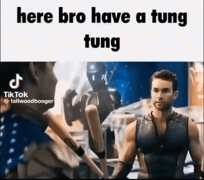 A Man In A Tank Top Is Holding A Bunch Of Baseball Bats In His Hands . GIF