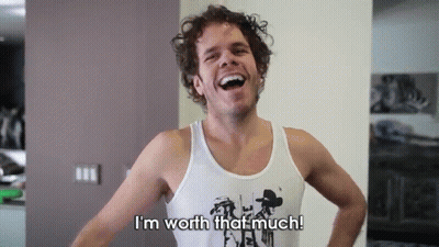 A Man In A Tank Top Is Laughing And Says I 'M Worth That Much GIF