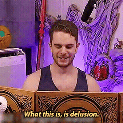 A Man In A Tank Top Is Reading A Book With The Words What This Is Is Delusion Below Him GIF