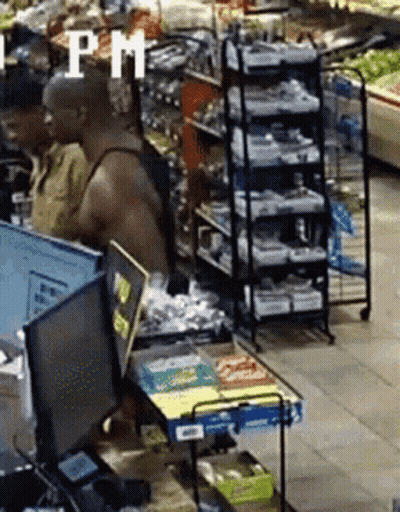 A Man In A Tank Top Is Standing In Front Of A Computer In A Grocery Store With A Sign That Says Pm GIF