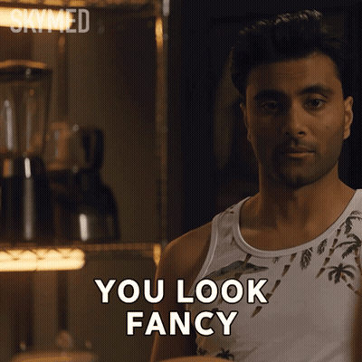 A Man In A Tank Top Says " You Look Fancy " In Front Of A Blender GIF