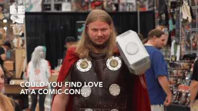 A Man In A Thor Costume Holds A Hammer And Says " Could You Find Love At A Comic-Con " GIF