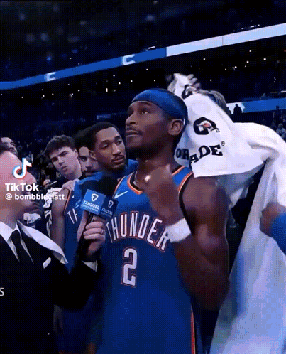 A Man In A Thunder Jersey Is Being Interviewed GIF
