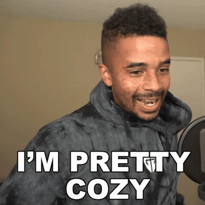 A Man In A Tie Dye Hoodie Says " I 'M Pretty Cozy " In Front Of A Microphone GIF