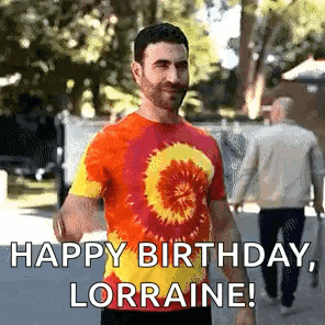 A Man In A Tie Dye Shirt Is Standing On A Sidewalk And Says `` Happy Birthday , Lorraine ! '' GIF
