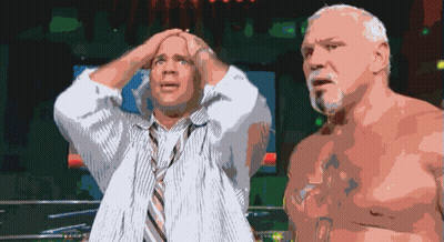 A Man In A Tie Holds His Head While Another Man Looks On GIF