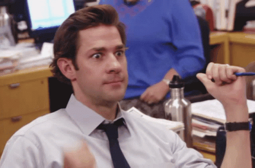 A Man In A Tie Is Holding A Pen In His Right Hand GIF