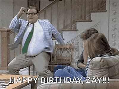 A Man In A Tie Is Jumping In The Air While A Woman Sits On A Couch And Says Happy Birthday Zay !!! GIF