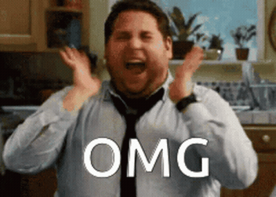 A Man In A Tie Is Making A Surprised Face And The Word Omg Is Above Him GIF