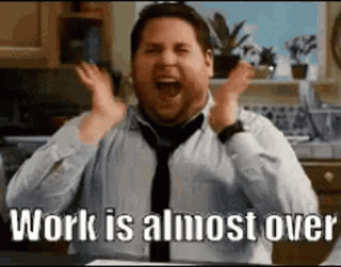 A Man In A Tie Is Screaming With His Hands In The Air And The Words `` Work Is Almost Over '' . GIF