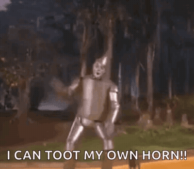 A Man In A Tin Man Costume Says " I Can Toot My Own Horn !! " GIF
