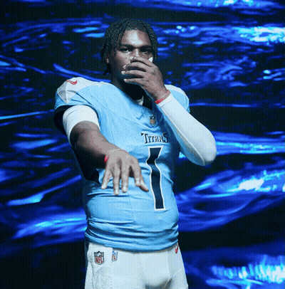 A Man In A Titans Jersey Covering His Mouth GIF