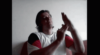 A Man In A Tommy Hilfiger Shirt Is Making A Funny Face GIF