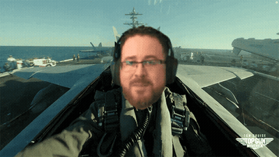 A Man In A Top Gun Maverick Fighter Jet Takes A Selfie GIF