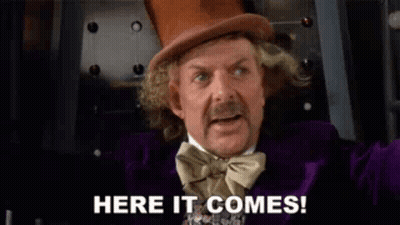 A Man In A Top Hat And Bow Tie Is Saying Here It Comes ! GIF