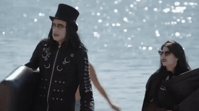 A Man In A Top Hat Holding A Beach Ball GIF
