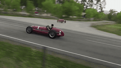 A Man In A Top Hat Is Driving A Red Race Car With The Number 1 On It GIF