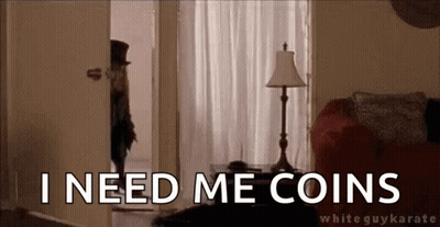 A Man In A Top Hat Is Standing In A Living Room With The Words `` I Need Me Coins '' Written On It . GIF