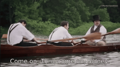A Man In A Top Hat Says " Come On Tom Come On Sidney " While Rowing A Boat GIF