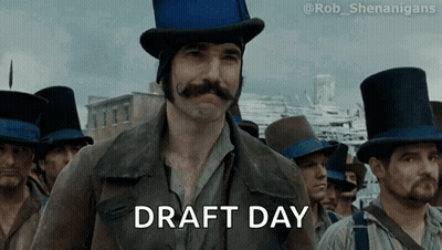 A Man In A Top Hat Says Draft Day In Front Of A Crowd GIF