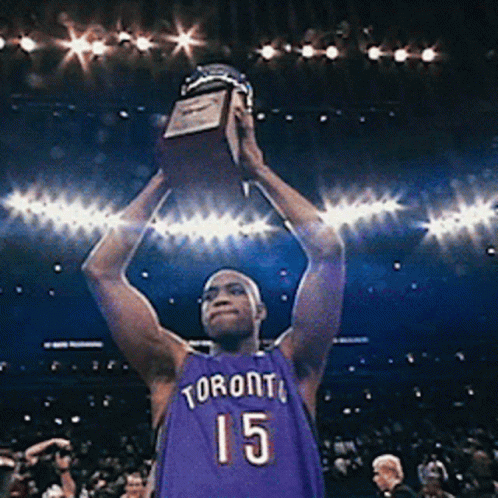 A Man In A Toronto Jersey Holds A Trophy In His Hands GIF