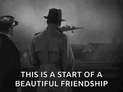 A Man In A Trench Coat And Hat Is Standing Next To A Man In A Hat Looking At A Plane Taking Off . GIF