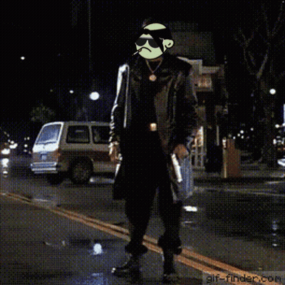 A Man In A Trench Coat Is Standing On A Street With A Gif-Finder.com Logo In The Corner GIF