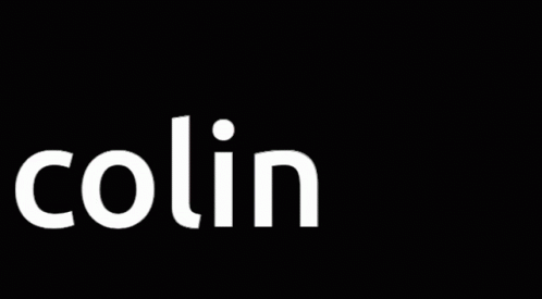 A Man In A Trench Coat Stands In Front Of The Name Colin X GIF