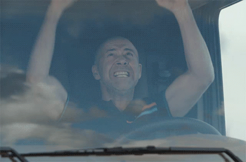 A Man In A Truck With His Arms In The Air And The Word Tg On The Bottom GIF