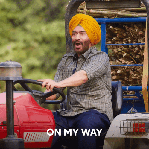 A Man In A Turban Is Driving A Tractor With The Words " On My Way " Behind Him GIF
