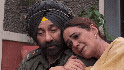 A Man In A Turban Is Hugging A Woman GIF