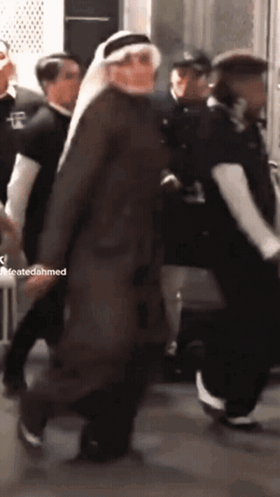 A Man In A Turban Is Walking In A Crowd Of People With A Caption That Says Createdahmed GIF