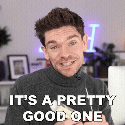 A Man In A Turtleneck Sweater Is Smiling With The Words It 'S A Pretty Good One Above Him GIF
