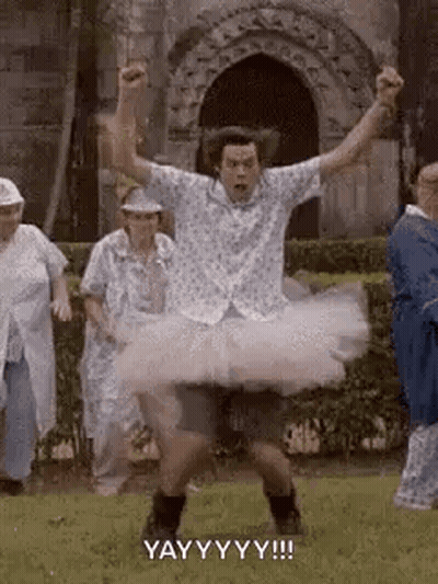 A Man In A Tutu Is Dancing In Front Of A Group Of Elderly People . GIF