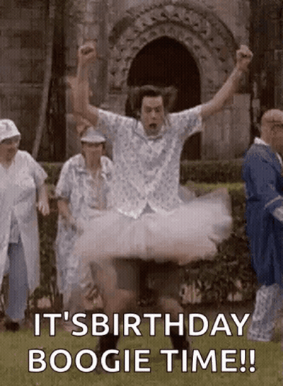 A Man In A Tutu Is Jumping In The Air While A Group Of People Are Standing Behind Him . GIF