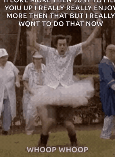 A Man In A Tutu Is Jumping In The Air While A Group Of People Watch . GIF