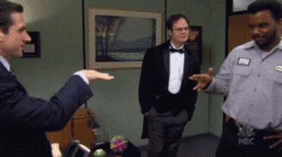 A Man In A Tuxedo And A Man In A Nbc Shirt GIF