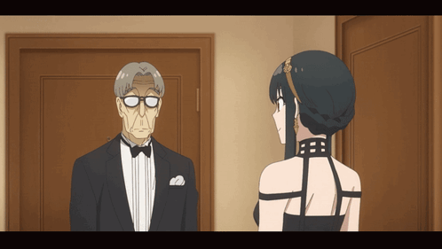 A Man In A Tuxedo And A Woman In A Black Dress Are Standing Next To Each Other GIF