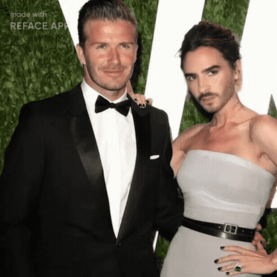 A Man In A Tuxedo And A Woman In A Strapless Dress Are Standing Next To Each Other GIF