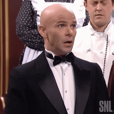 A Man In A Tuxedo And Bow Tie Has Snl Written On His Shirt GIF