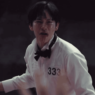 A Man In A Tuxedo And Bow Tie Has The Number 333 On His Shirt GIF