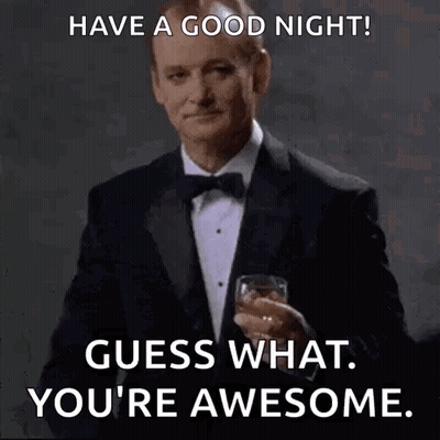 A Man In A Tuxedo And Bow Tie Is Holding A Glass Of Whiskey . GIF