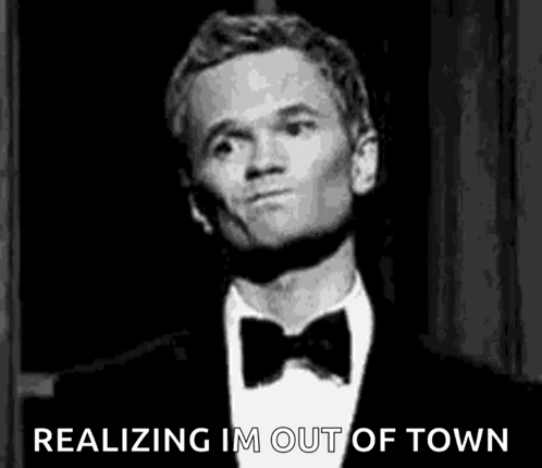 A Man In A Tuxedo And Bow Tie Is Making A Funny Face . GIF