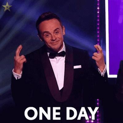 A Man In A Tuxedo And Bow Tie Is Making A Gesture With His Hands And The Words One Day Are Behind Him . GIF
