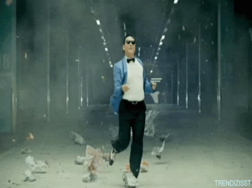 A Man In A Tuxedo And Bow Tie Is Running Through A Smokey Tunnel GIF